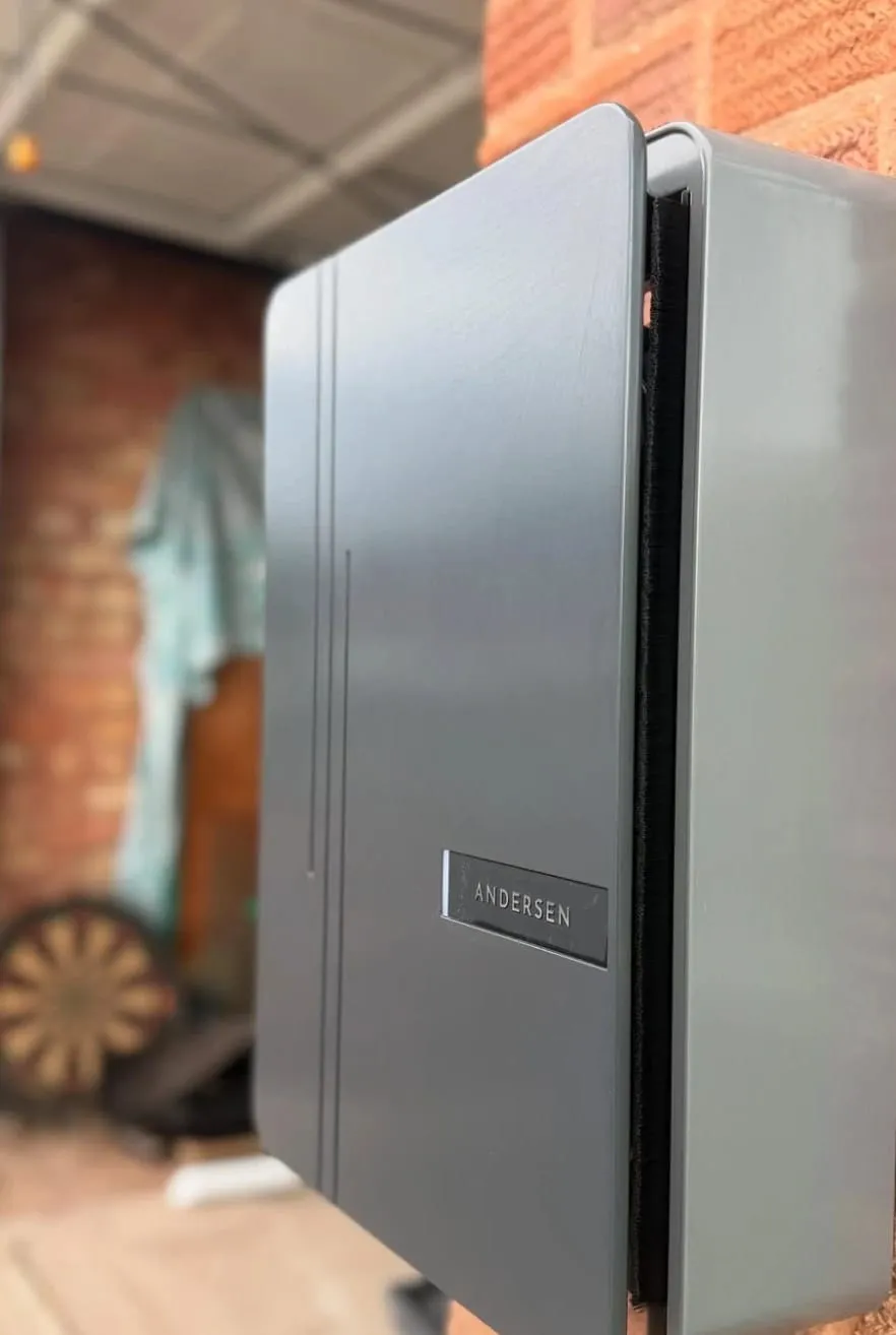 Close-up of a grey Andersen EV charger installed on a brick wall in Bromyard