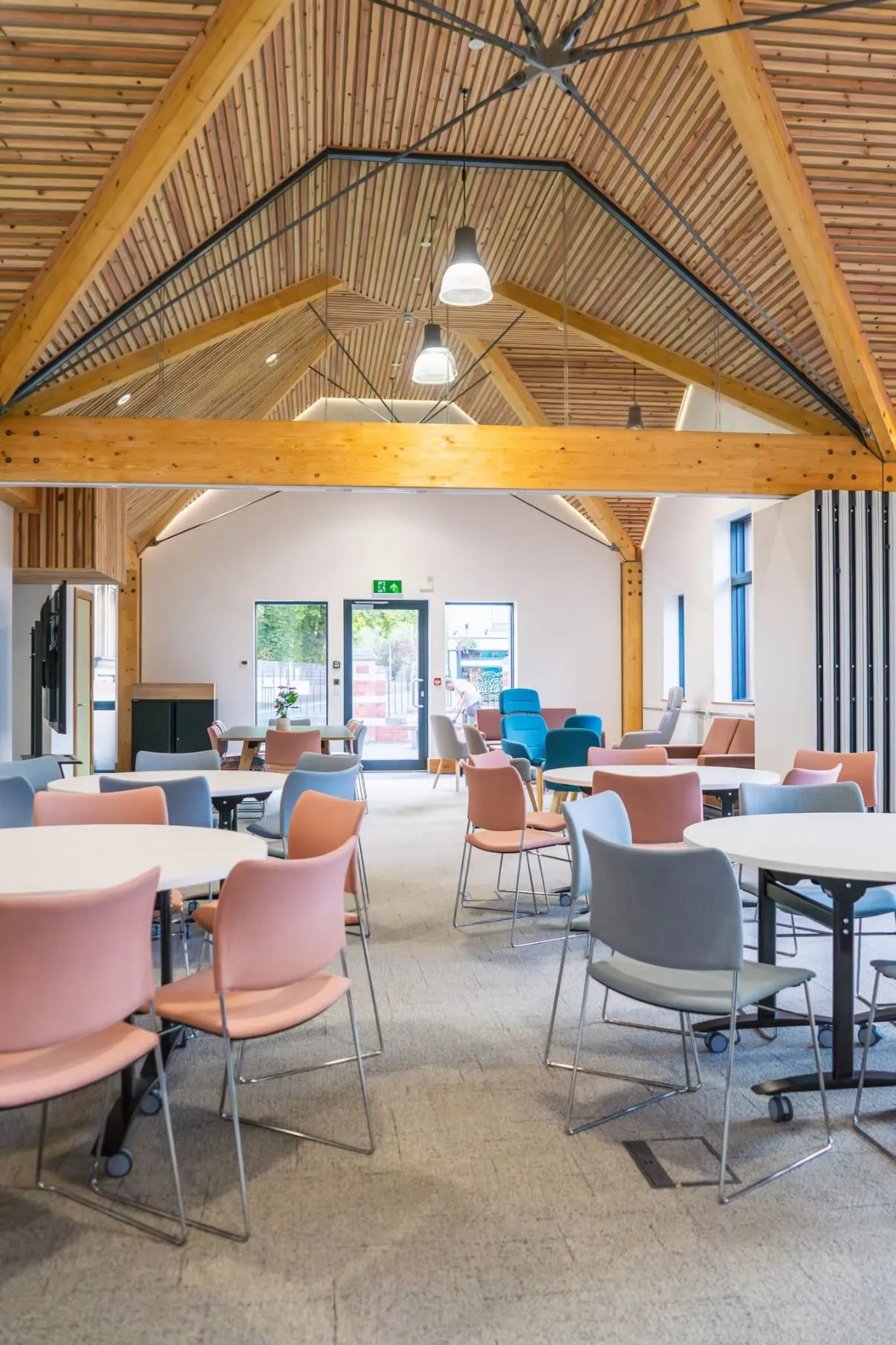 Pendant and LED cove lighting under the exposed timber-vaulted ceiling at NMITE's Centre for Innovation and Future Skills in Hereford