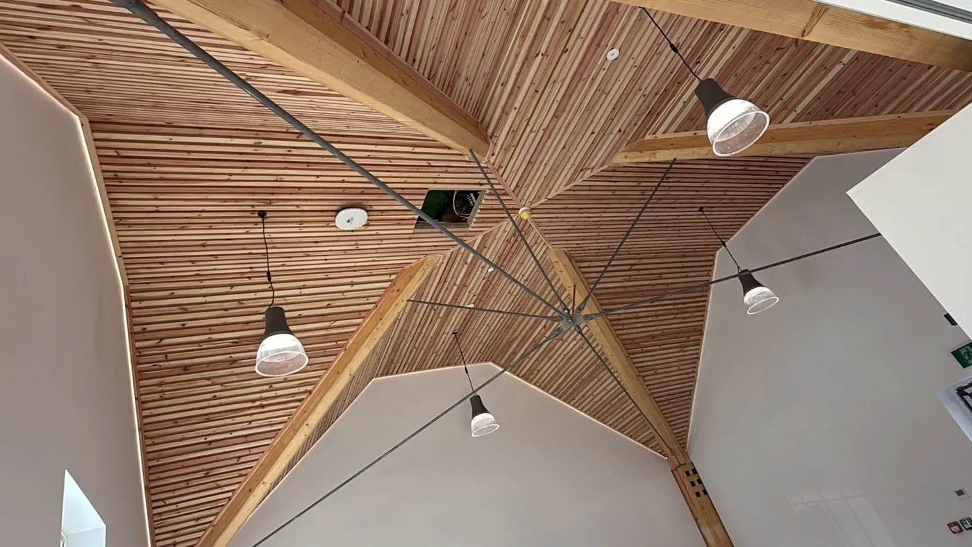 Pendant lighting installed under the timber-vaulted ceiling of a new commercial building in Herefordshire