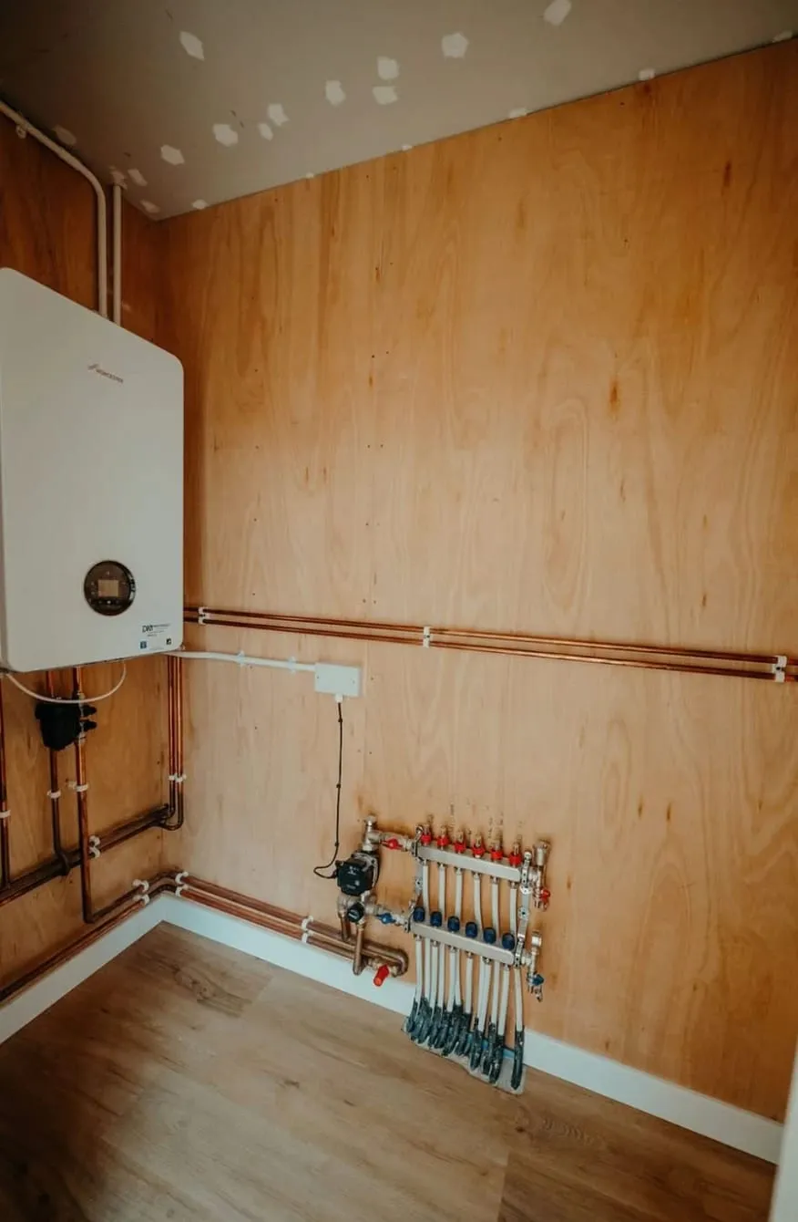 Boiler, wiring centre and underfloor heating manifold wired by TR Electrical in a Weobley plant room
